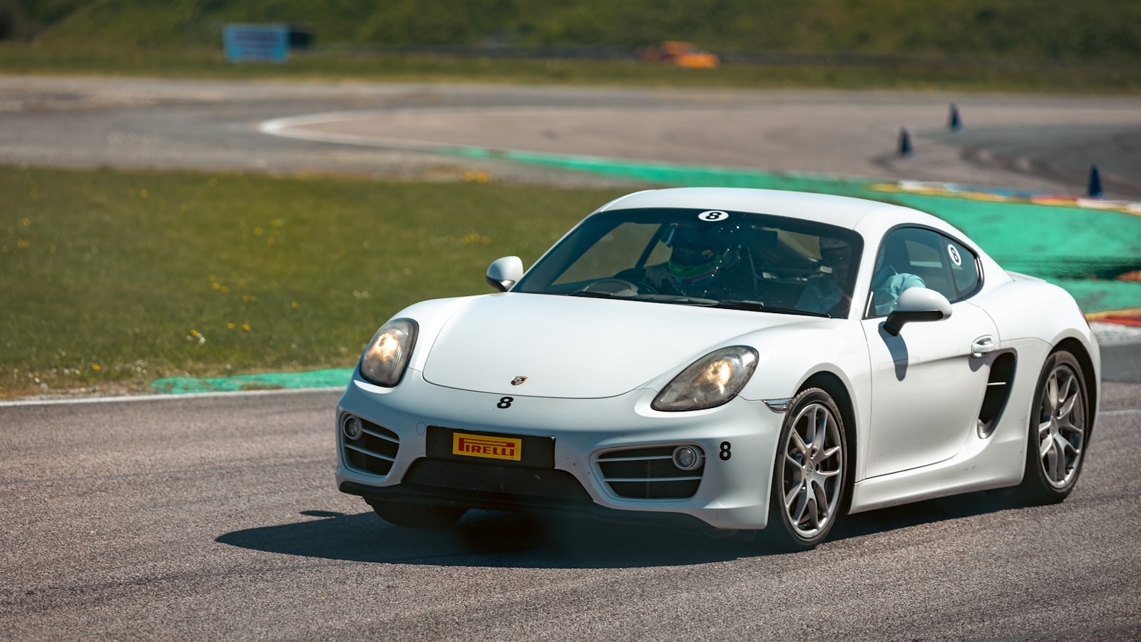 A Porsche 718 Cayman GT4 RS on track, photographed in motion through a corner