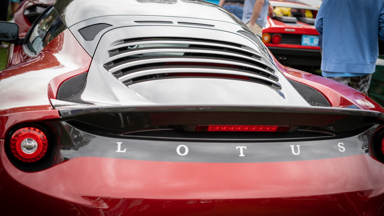 A grey Lotus Evora 410 Sport photographed three-quarter front in a workshop