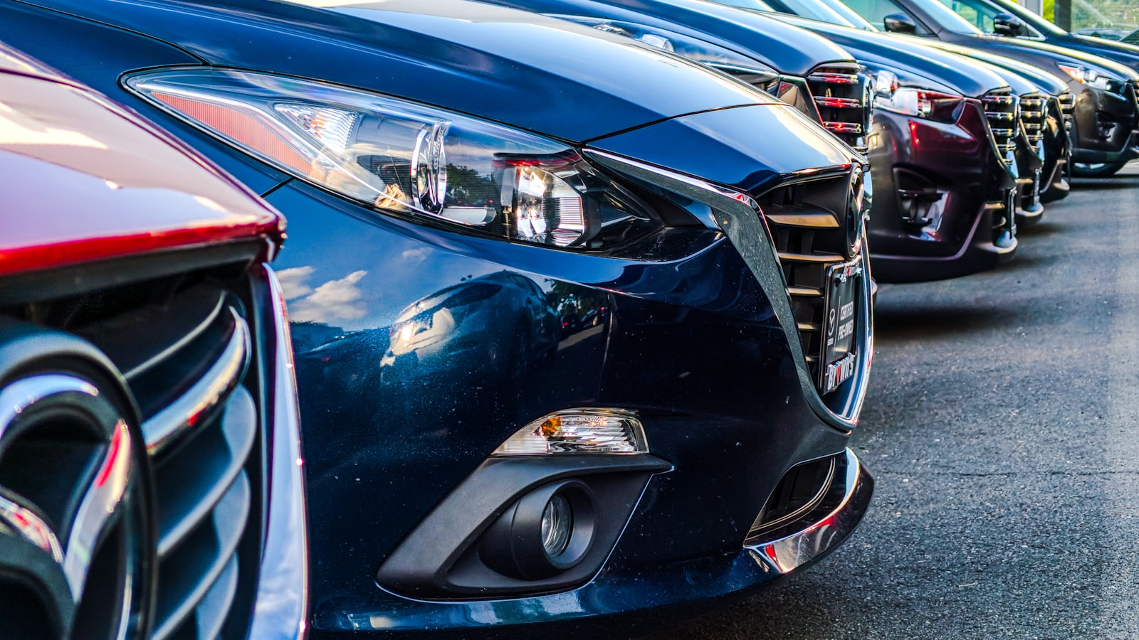A classic car displayed under lights at an auction event