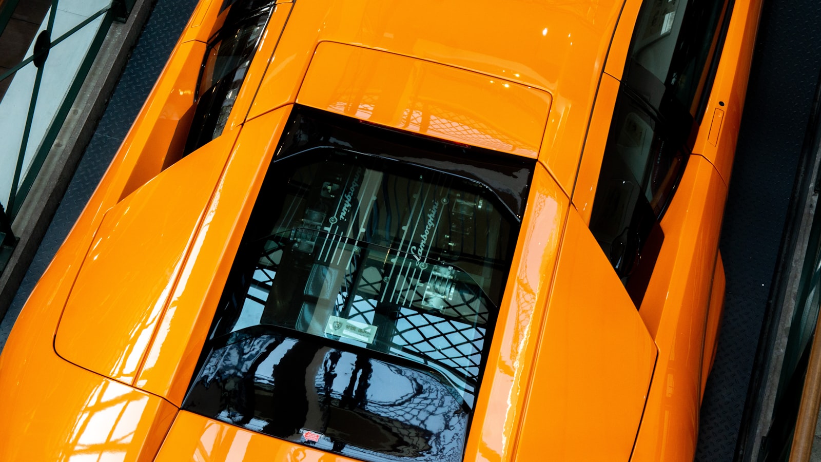 A Lamborghini Murciélago photographed on a city street at dusk